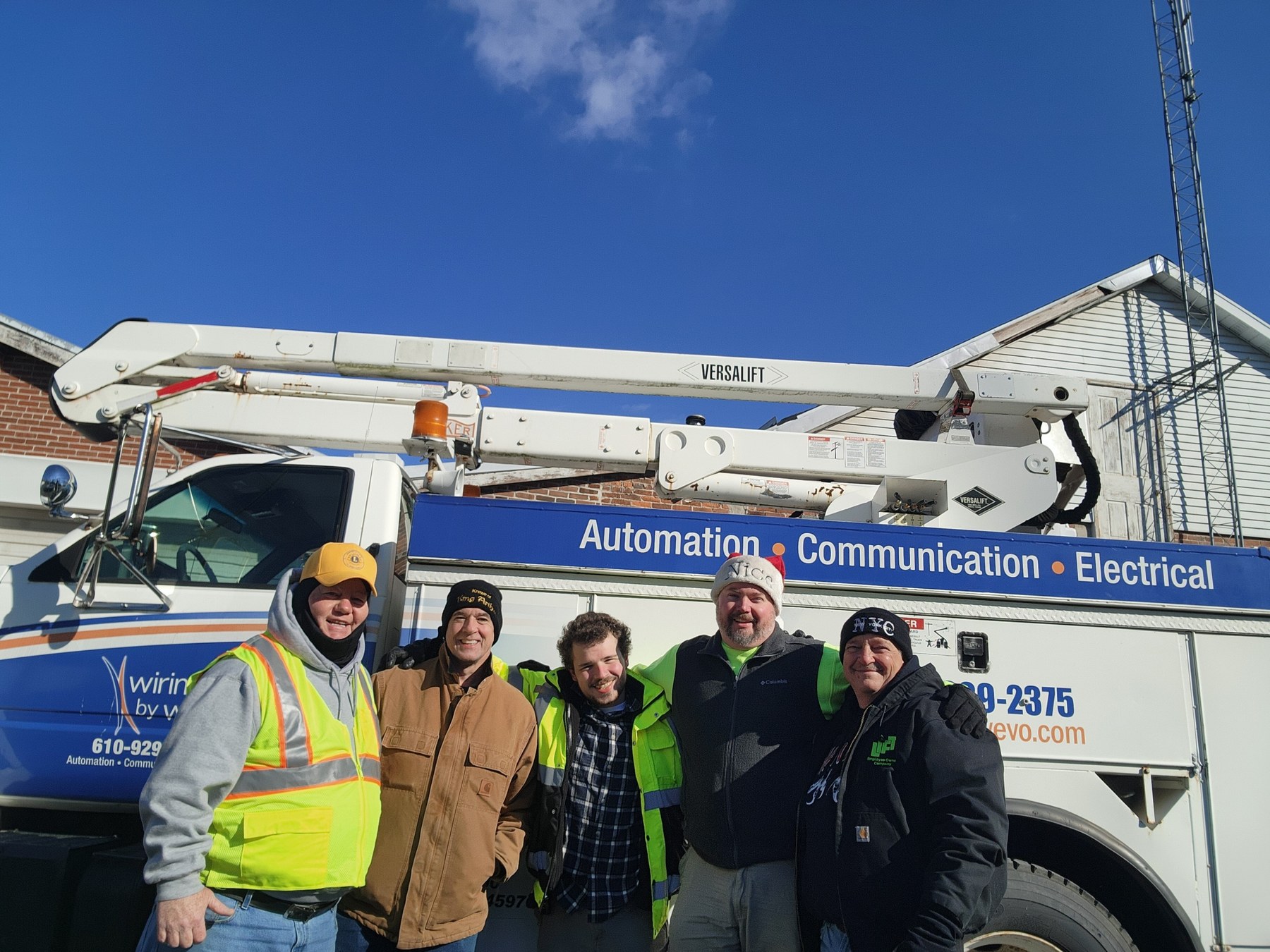Community volunteers with utility truck during Christmas lights installation